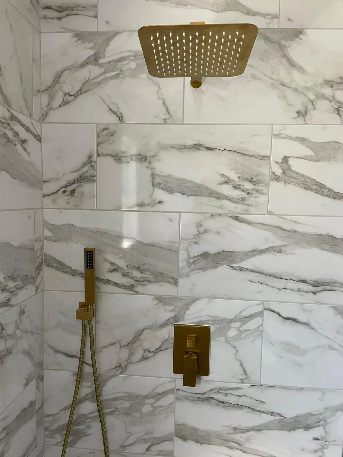 Finished marble bathroom with designer gold fixtures